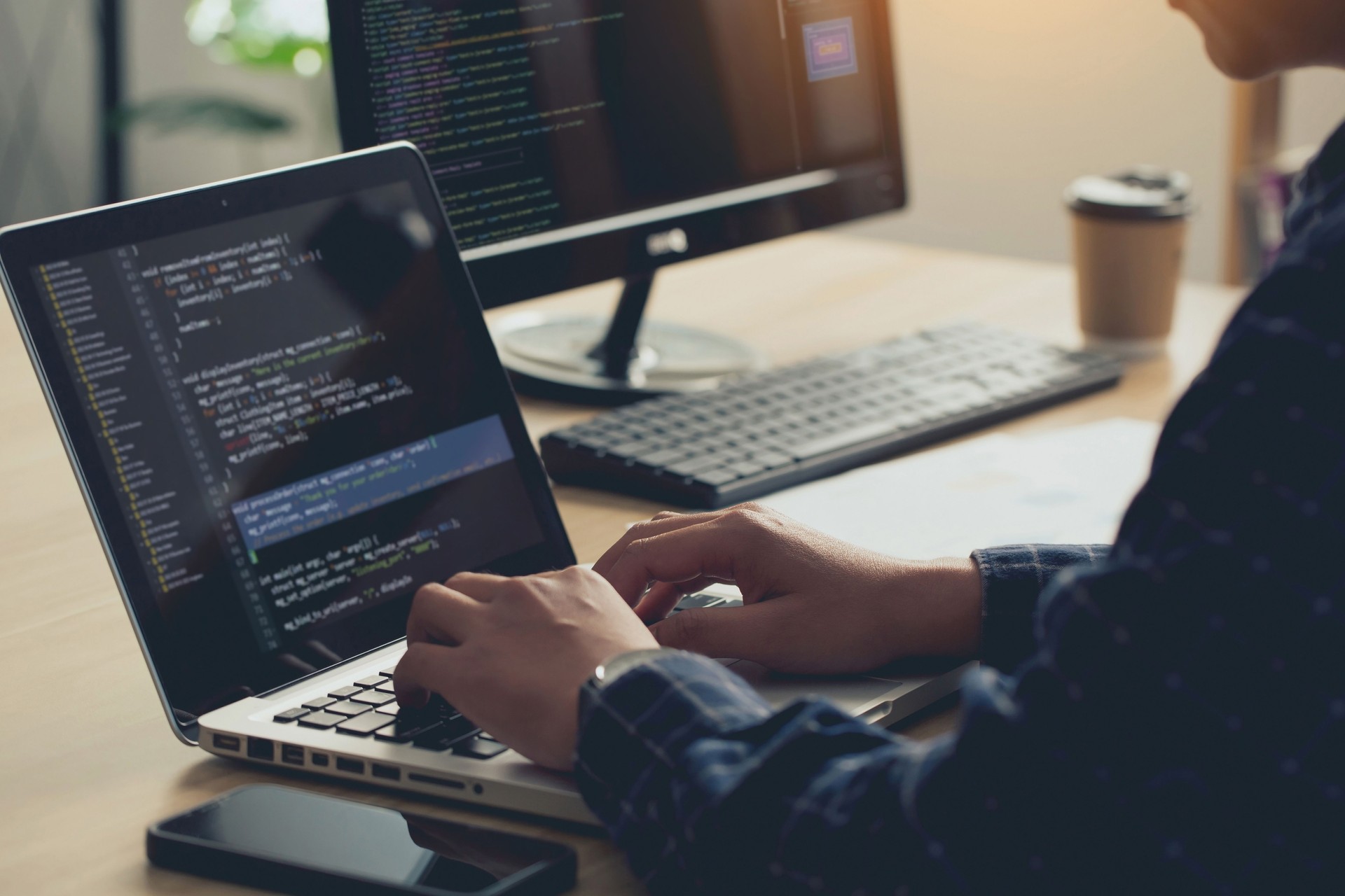 Professional Development programmer typing on a laptop Computer Keyboard. Screens Show Coding Language User Interface. Program Development, software, and coding technology, artificial chat, Website design.